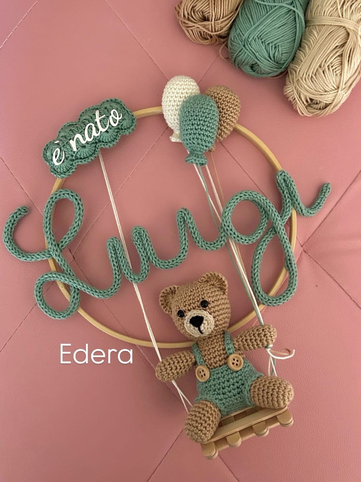 Sage green “Luigi is born” birth hoop with a teddy bear on a swing and balloons