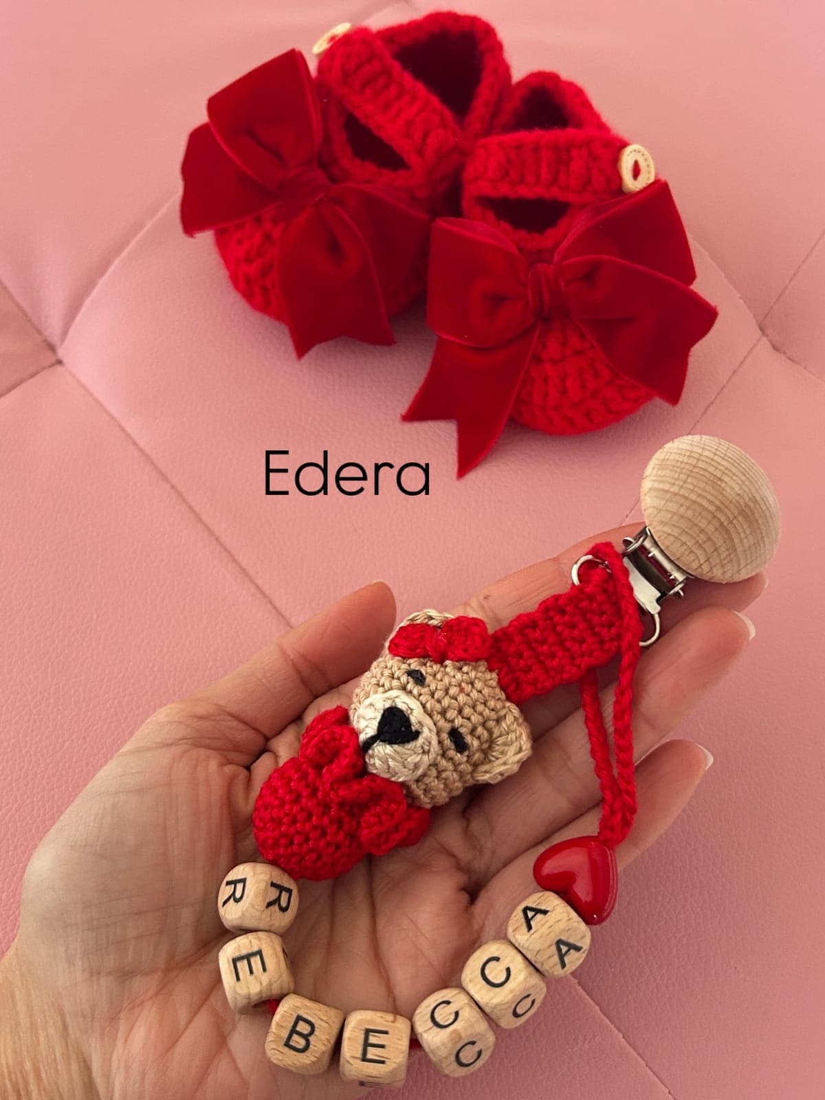 Pacifier clip with the name Rebecca and a teddy, matched with red crochet booties