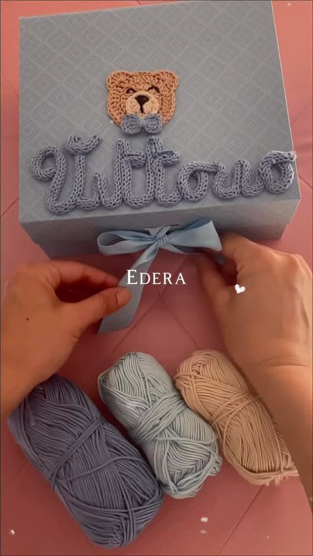 Blue gift box with the name Vittorio and a crochet teddy on the lid