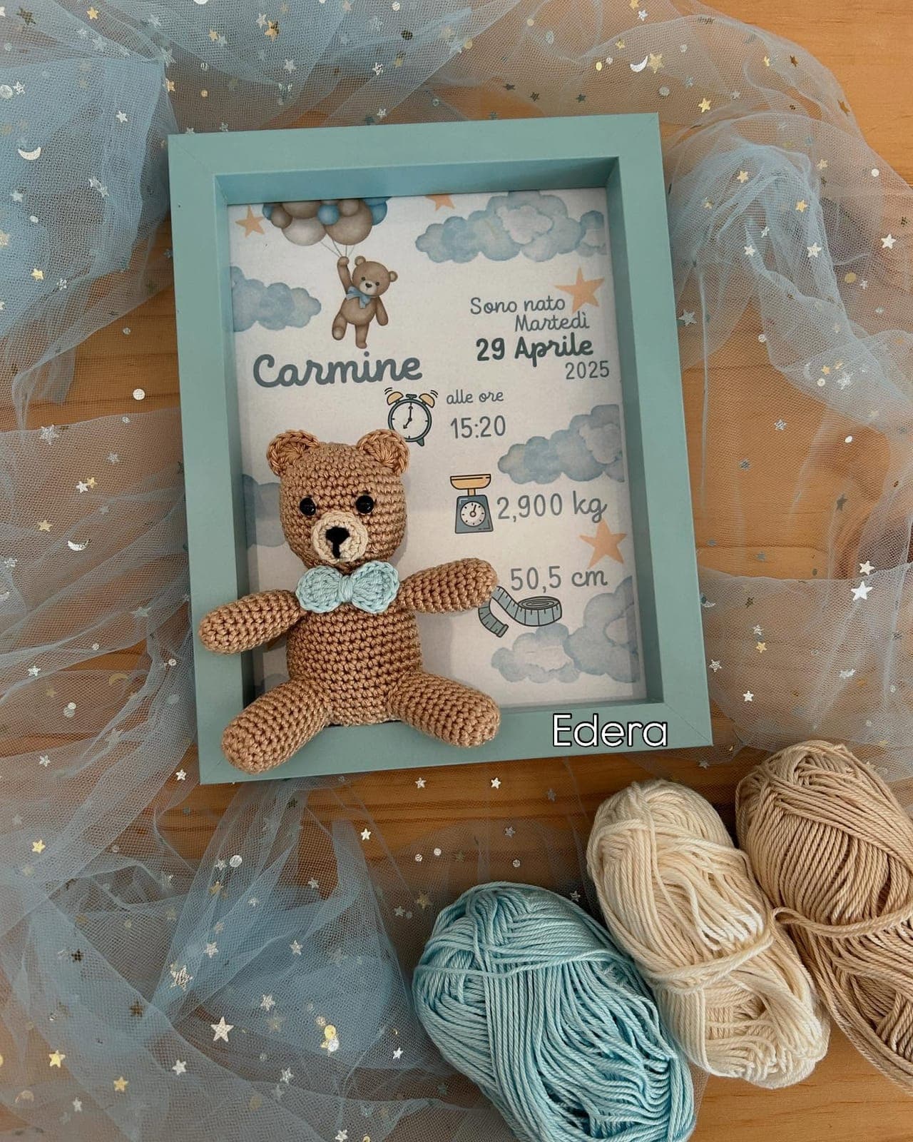 Blue birth frame with an amigurumi teddy bear and Carmine's birth details